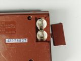 a close up of a brown telephone on a white surface