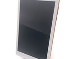 a tablet that is sitting on a stand on a table