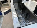 a stainless steel sink in the middle of a kitchen