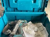 a blue tool box with tools in it sitting on the floor