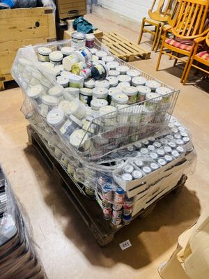 many containers of food sitting on a pallet in a room