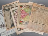 several old newspapers are stacked on top of each other on a table