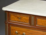 a marble top on a wooden chest of drawers