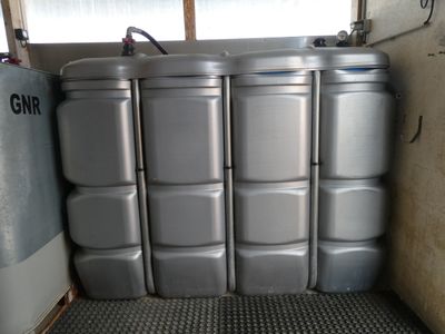 a group of metal containers stacked up in a room