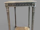 an antique table with a wicker top and a wicker bottom