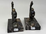 pair of bronze figurines of a man and a woman on marble bases