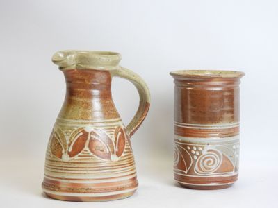 two brown vases sitting next to each other on a table