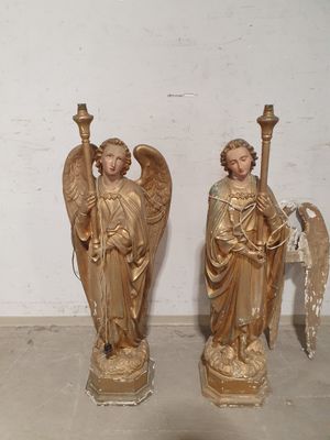 two statues of angels standing next to each other