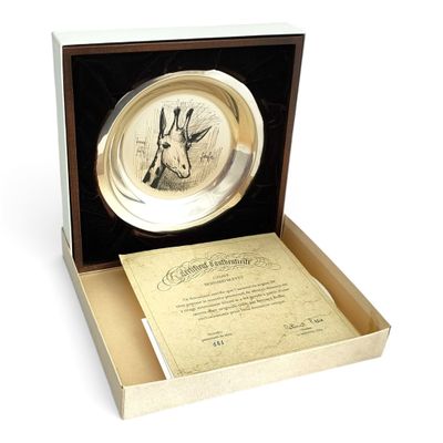 a silver plate with a picture of a giraffe in it