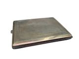 an antique silver cigarette case with a cigarette in it