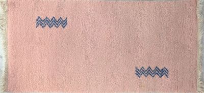 tapis rose et bleu orné d'un motif en zigzag