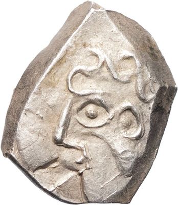une pièce de monnaie ancienne sur laquelle est gravé le visage d'un homme