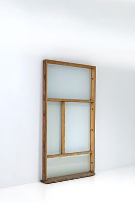 an empty room with a window and a white wall