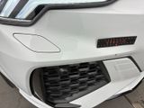 a close up of the front bumper of a white car