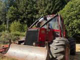 a red tractor that is parked in the grass