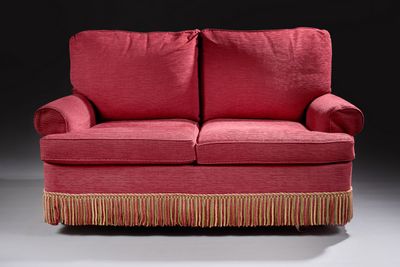 an image of a red couch with fringes on it
