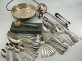 an assortment of silverware including spoons, forks, and a bowl