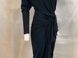 the dress is black and has long sleeves and a tie around the waist