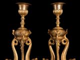 two gold vases sitting next to each other on a table