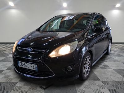 la voiture noire est garée sur un sol en damier dans le garage