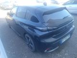 the rear end of a black car parked in a parking lot