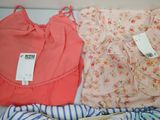 two pieces of clothing that are laying on a bed