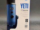 an image of a blue microphone sitting on top of a box