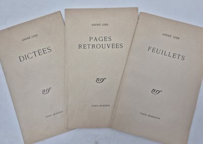 three pages of a book sitting on top of a white table