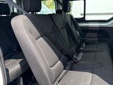 the interior of a white van with grey seats and a black seat belt