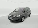 the small grey car is parked in a white room