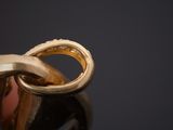 a person holding a ring with a diamond in it