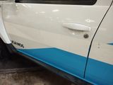 a white car with a blue stripe on the side of it