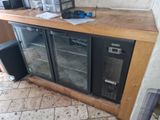 a refrigerator with a glass door sitting on a counter