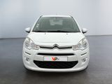 the front of a white citrole parked in a room