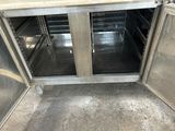 a metal cabinet with two doors open on the floor