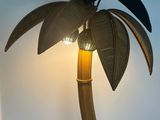 a lamp that has a palm tree on top of it