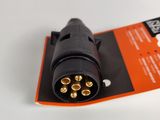 an orange and black power cord plug on top of a white table