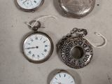 many different types of pocket watches on the table