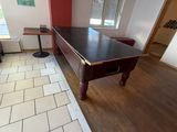 a pool table in the middle of the room