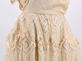 an image of a beige dress with a frillying skirt on a mannequin mannequin