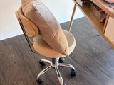 a desk with a chair and a laptop on it