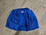 blue jacket laying on the floor on a wooden floor