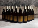 six bottles of wine are lined up in a row on a table