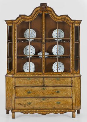an antique display cabinet with a clock on top of it