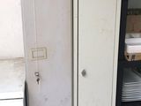 a metal cabinet in the corner of a room