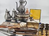 a lot of silver items that are sitting on a table