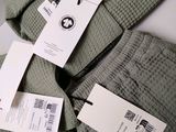 a pair of pants with tags on them on a table