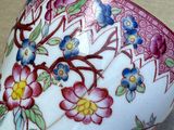 a cup with a floral design on it on a table