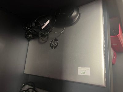 a laptop computer sitting on top of a metal shelf