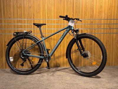 a bike that is parked in front of a wooden wall
